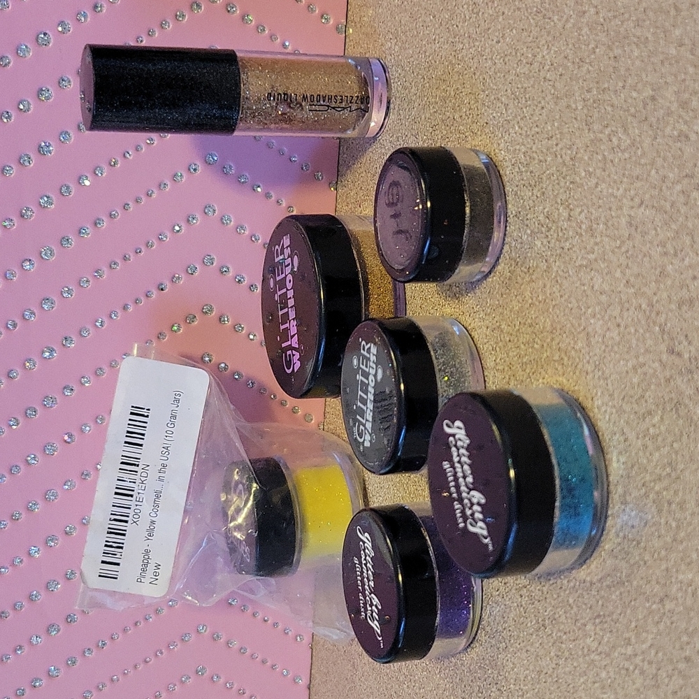 Assortment of glitter makeup, loose glitter and one Mac dazzleshadow liquid